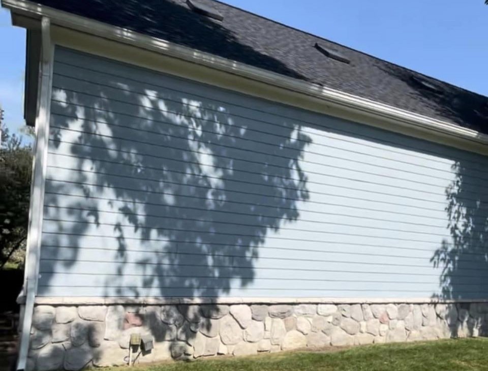 Newly installed blueish colored vinyl siding on residential home