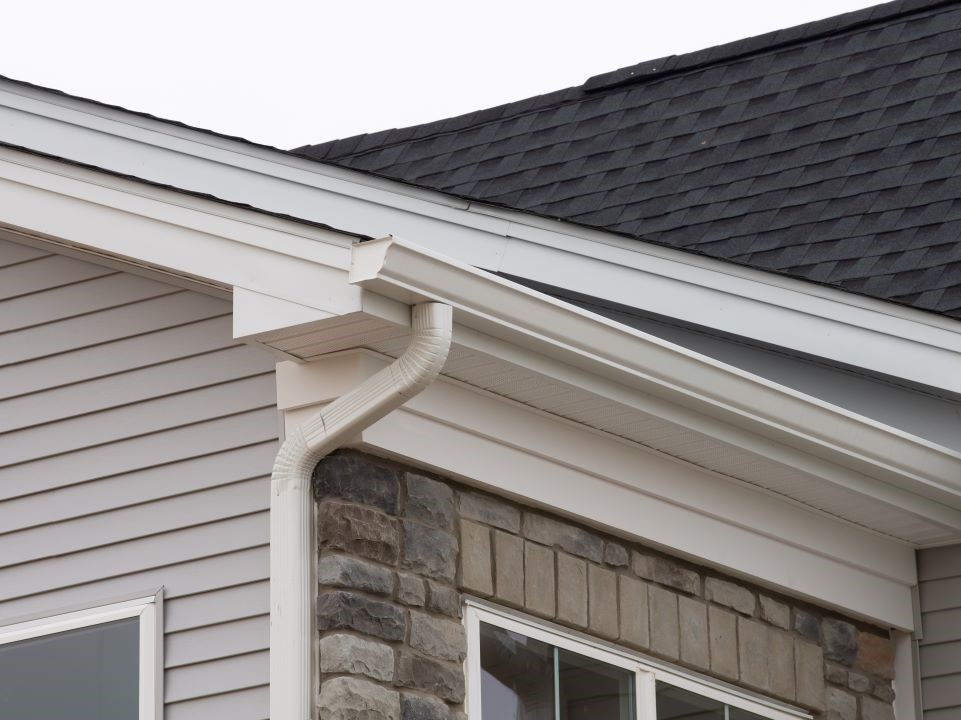 Stock image of cream colored gutter on a residential home